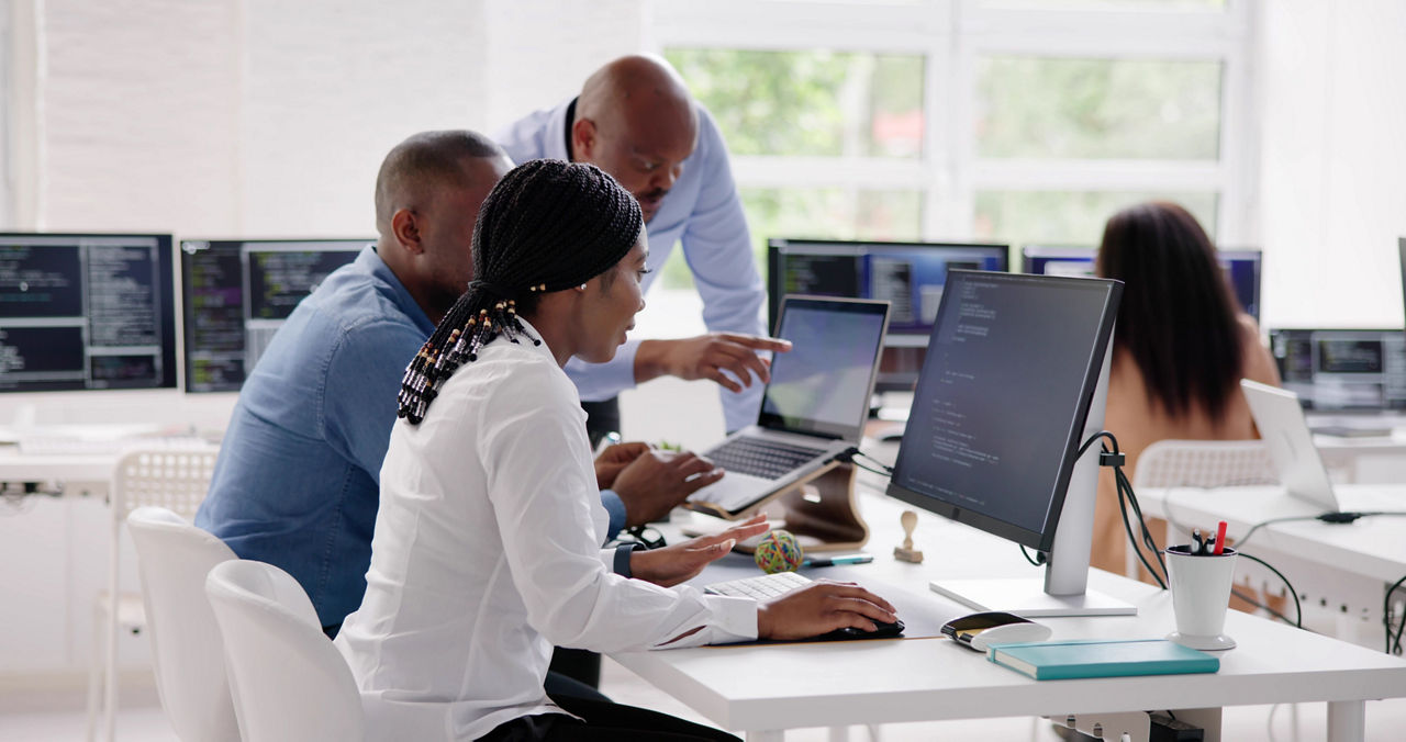 African Business Team Working On Computer. Software App Development