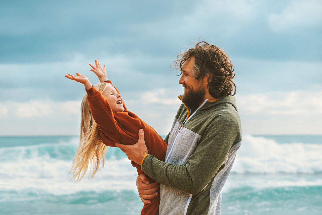Family fun father and daughter playing together outdoor cheerful kid with dad summer vacations lifestyle on the beach candid emotions Father's day holiday