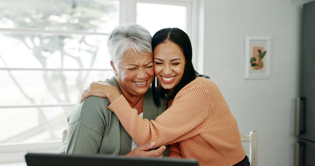 Senior woman, hug and laptop with support in home with tech learning and helping with internet banking. Family love, mom and embrace with smile, happy and care with planning and digital assistance.