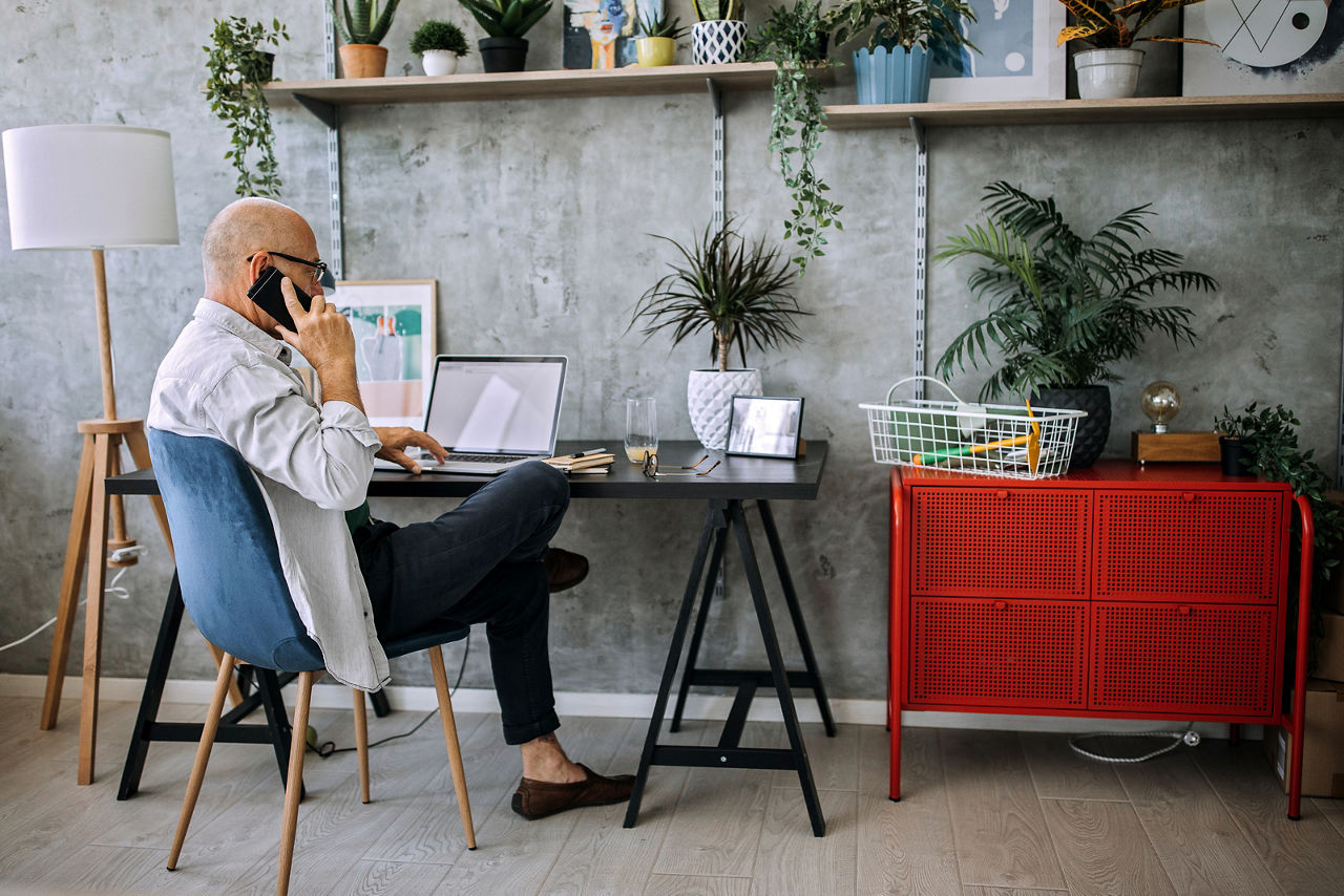 Senior man working from home on a laptop
