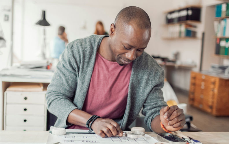 Small business owner works on a design for a client. 