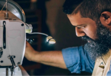 A craftsman works with a piece of machinery.