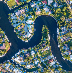 Arial shot of a river winding through a residential neighborhood