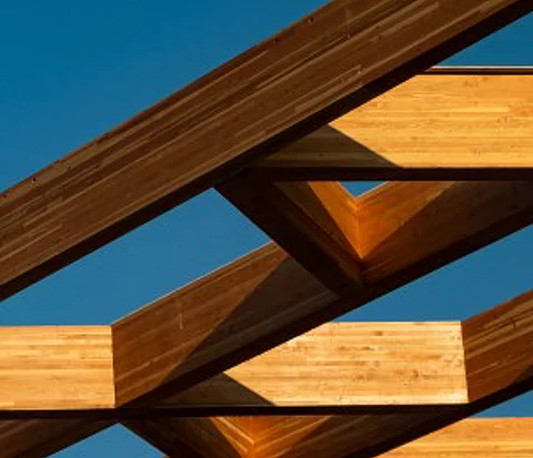 A cropped shot of wood beams on the exterior of a house. 