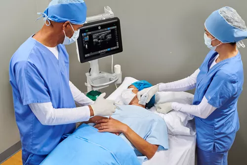 anesthesiologist using the Venue Fit to administer anesthesia into a patient's back