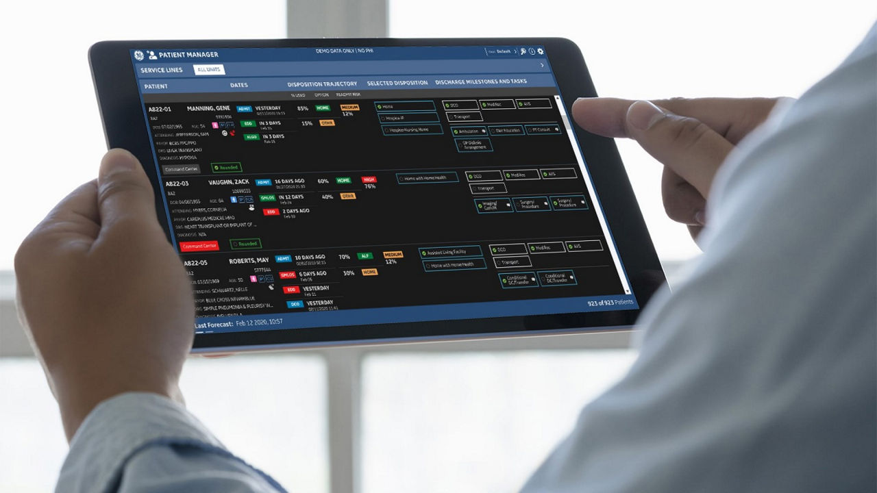 Healthcare professional using a tablet with patient management software.