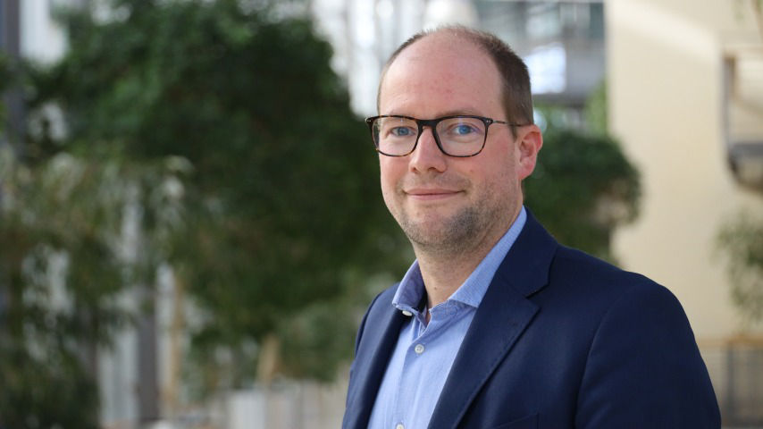 A clinician doing an ultrasound on a patient's stomach
