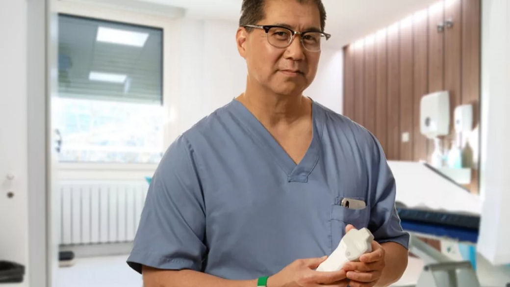 medical professional holding a Vscan ultrasound 