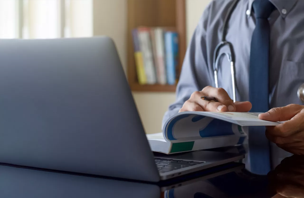 Cardiologist reading a medical journal