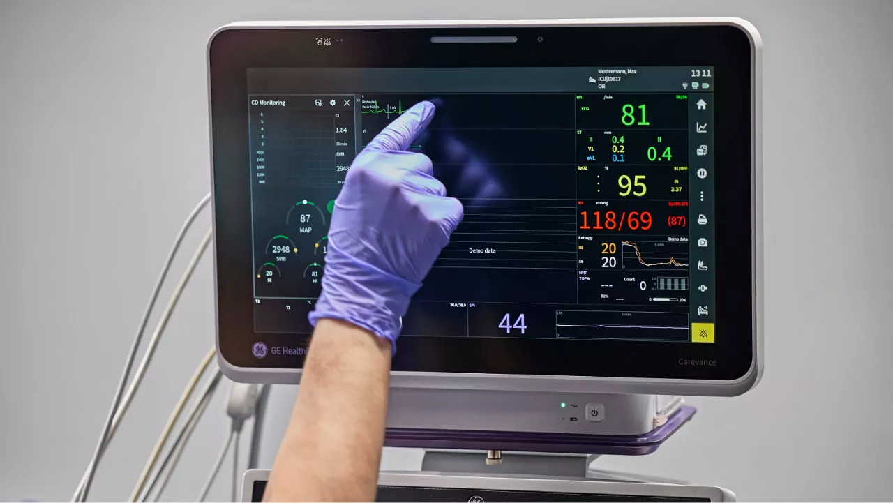 clinician working with a patient monitor