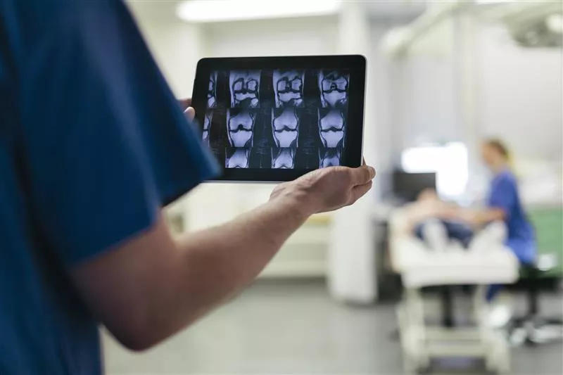 Doctor Showing MRI Images on Digital Tablet