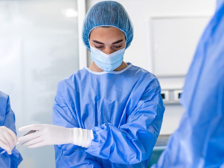 Physician with scrubs and mask in operating room