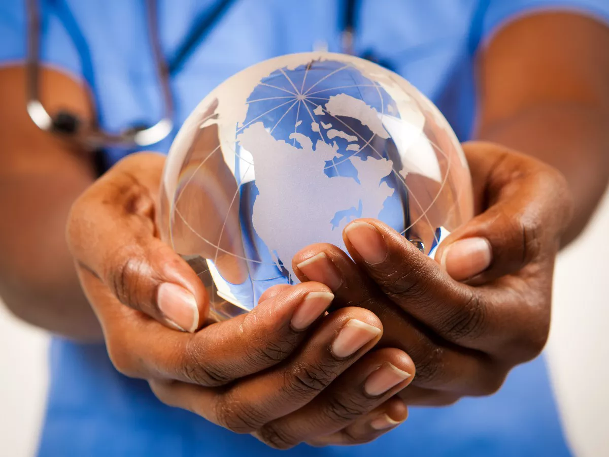 african-american-nurse-holding-crystal-globe-in-hands