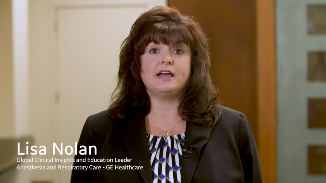 Image of a woman (Lisa Nolan) in a black blazer with a stripped blouse.