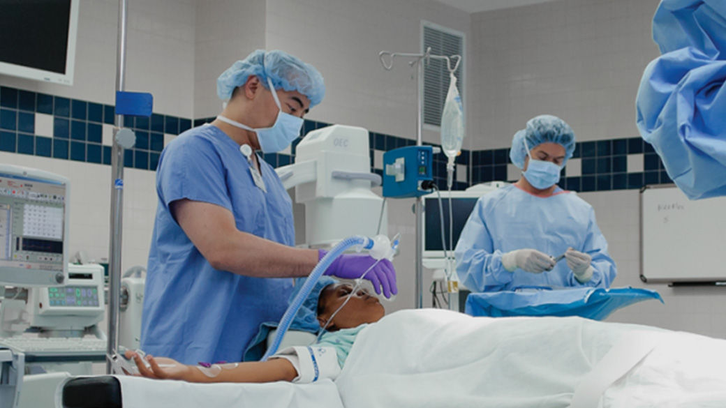 an anesthesiologist administering anesthesia on a patient in an operating room
