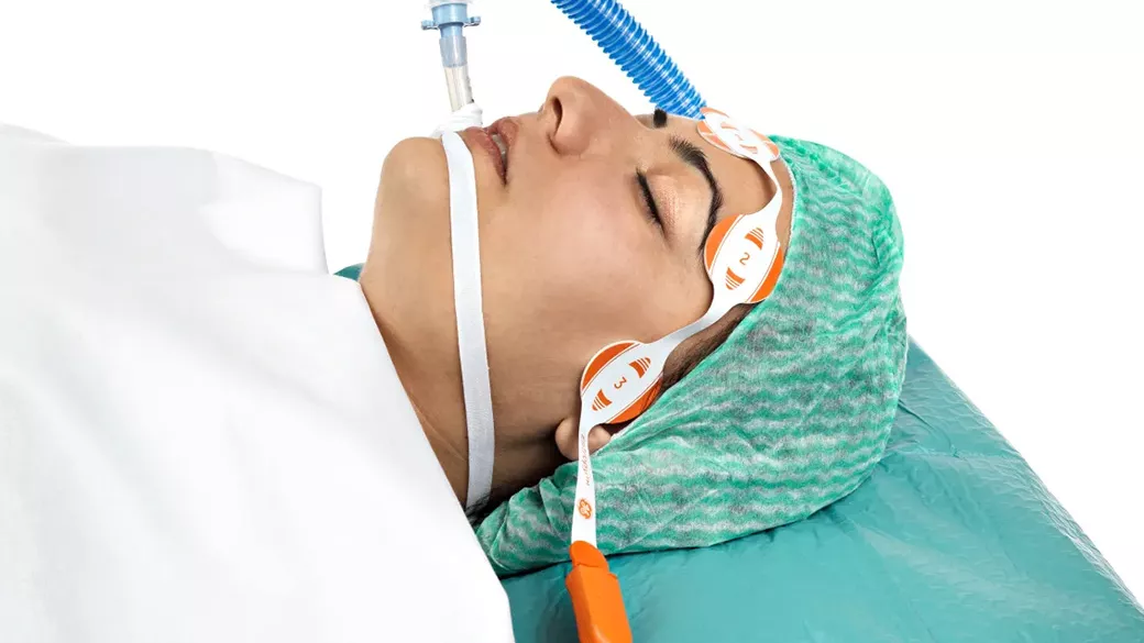 Patient on a hospital bed hooked up to monitoring systems