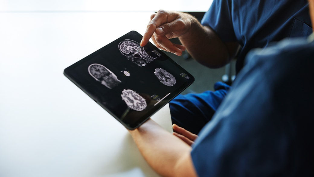 Clinicians reviewing scans on a tablet