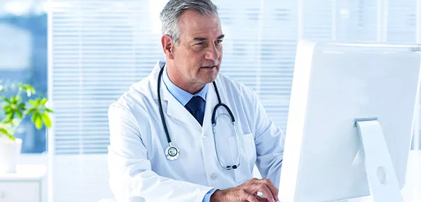 Doctor in a white coat with stethoscope around his neck