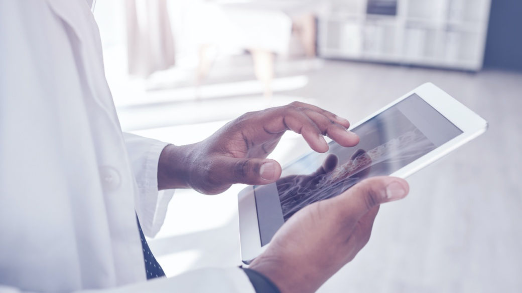 A clinician reviewing clinical images on a tablet-style device