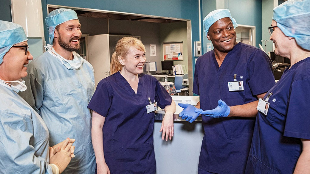 Five clinicians gathered around a desk