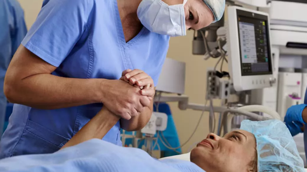 Clinician holding a patient's hand