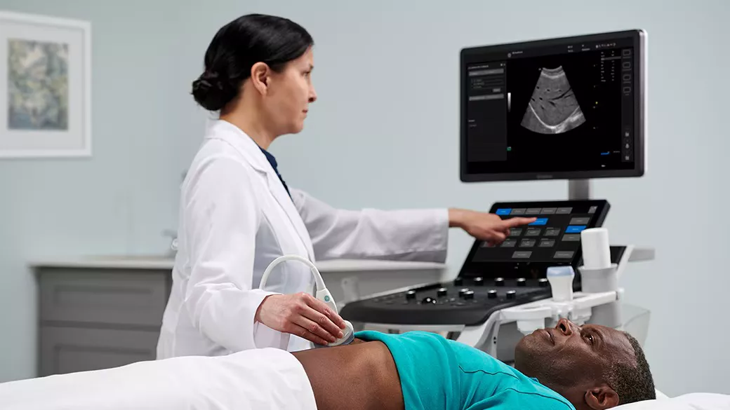 Clinician using an ultrasound machine on a patient