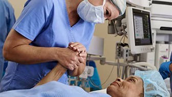 Clinician holding a patient's hand