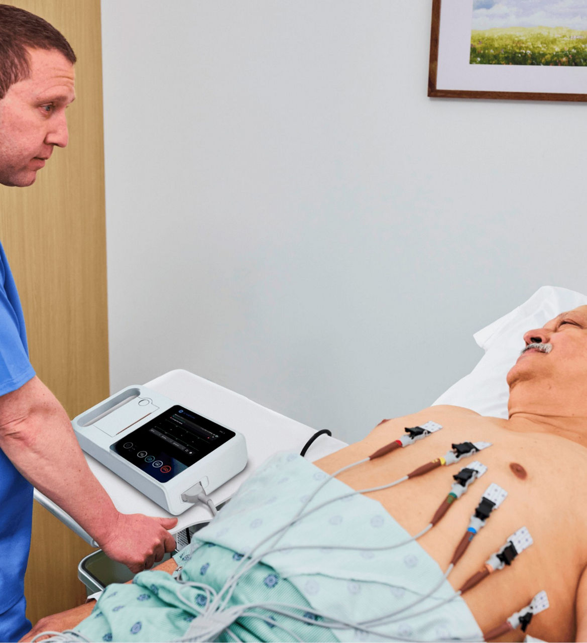 Clinician using MAC 3 with lead wires attached to patient lying down in bed.