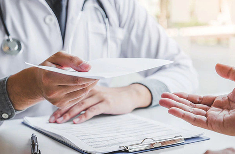 Doctor handing documents to another person