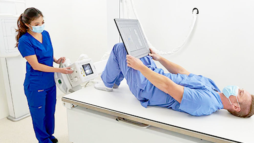 Radiologist using the x-ray system with patient laying on the table