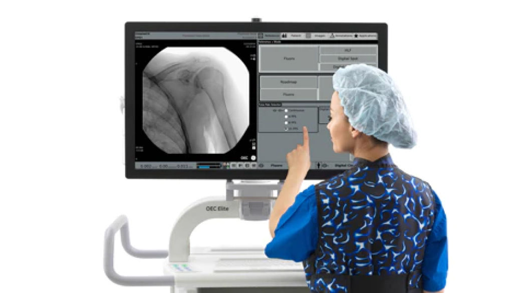 Clinician standing in front of screen