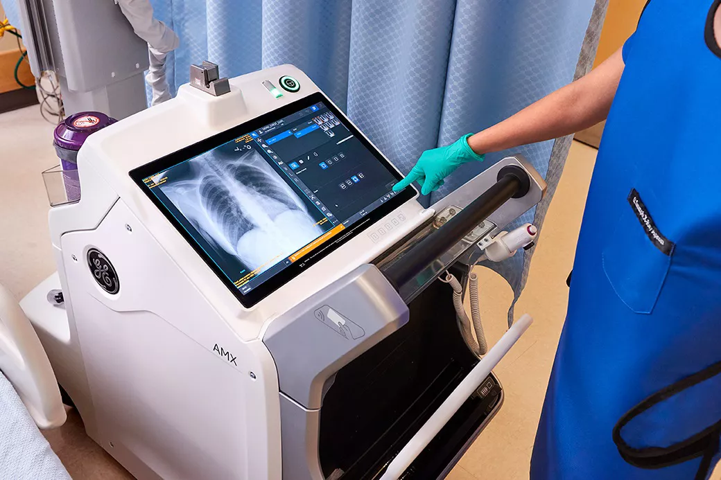 Radiology technician using the digital touchscreen on the AMX Navigate during image capture