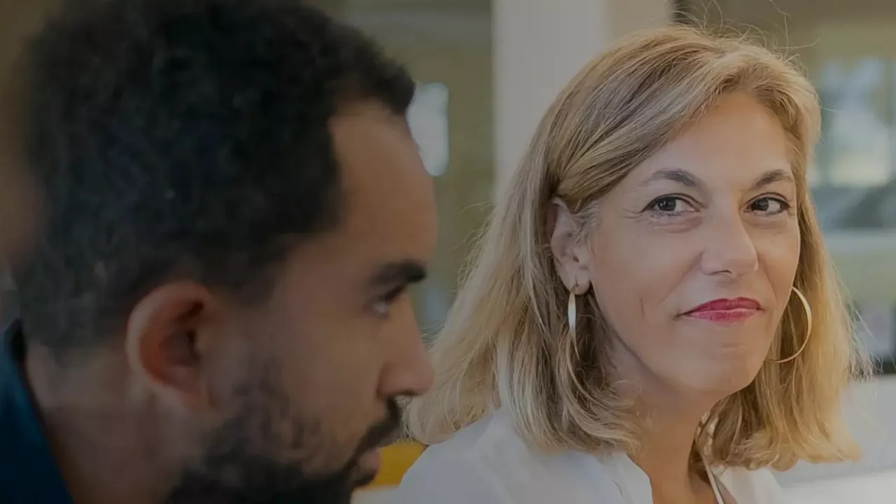 Two coworkers sitting next to each other with focus on faces