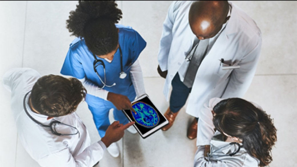 Top view of clinicians reviewing scans on a tablet