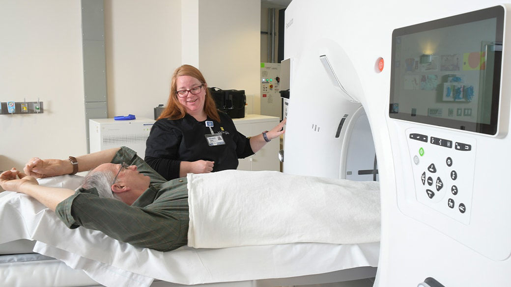 Clinician and patient getting ready for an MRI