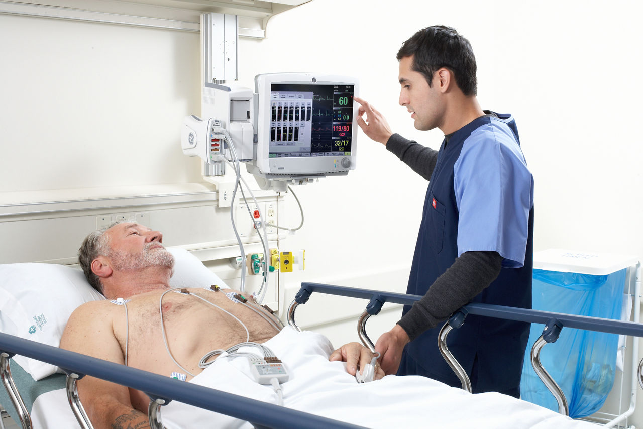 Nurse accompanying a patient on a gurney.