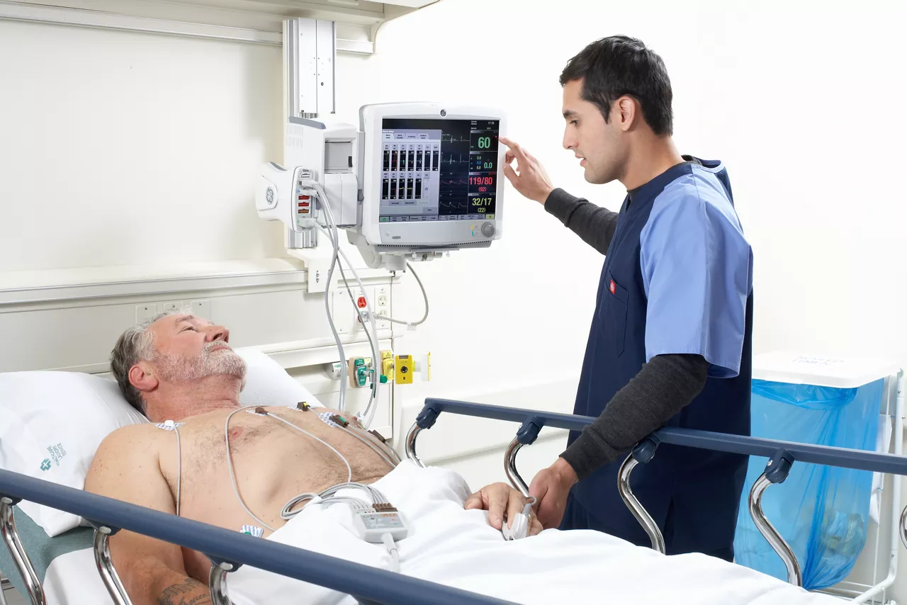 Nurse accompanying a patient on a gurney.