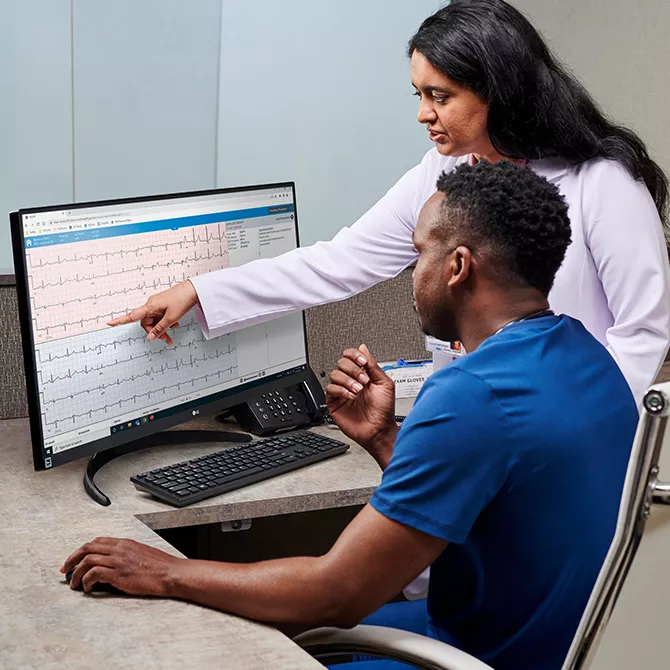 Clinicians reviewing ECG data on  MUSE? NX