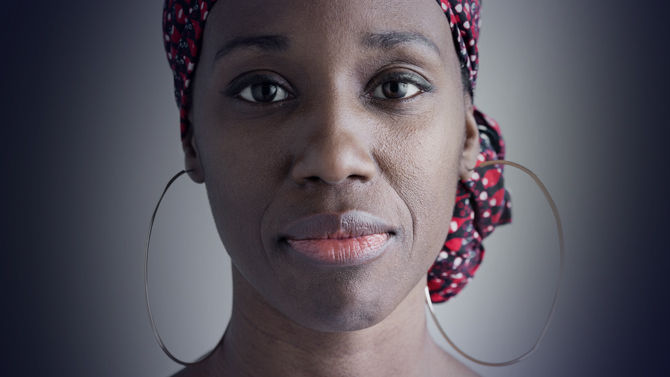 Woman faced directly at camera on green background