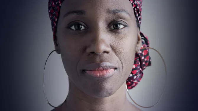 Woman faced directly at camera on green background