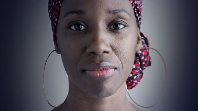 Woman faced directly at camera on green background