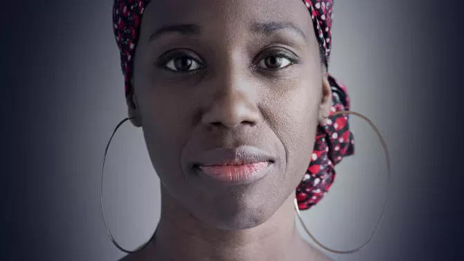 Woman faced directly at camera on green background