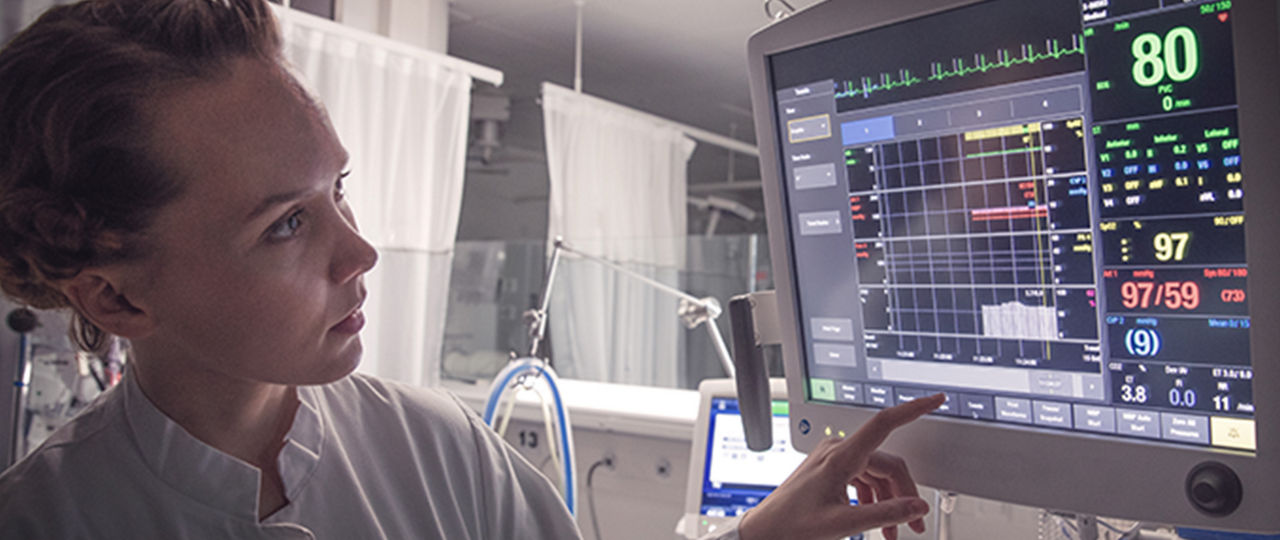 Healthcare worker monitoring a screen
