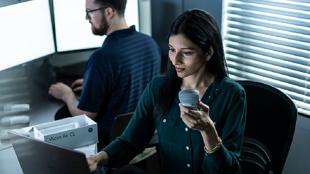 Person holding a Handheld Ultrasound and another person behind her