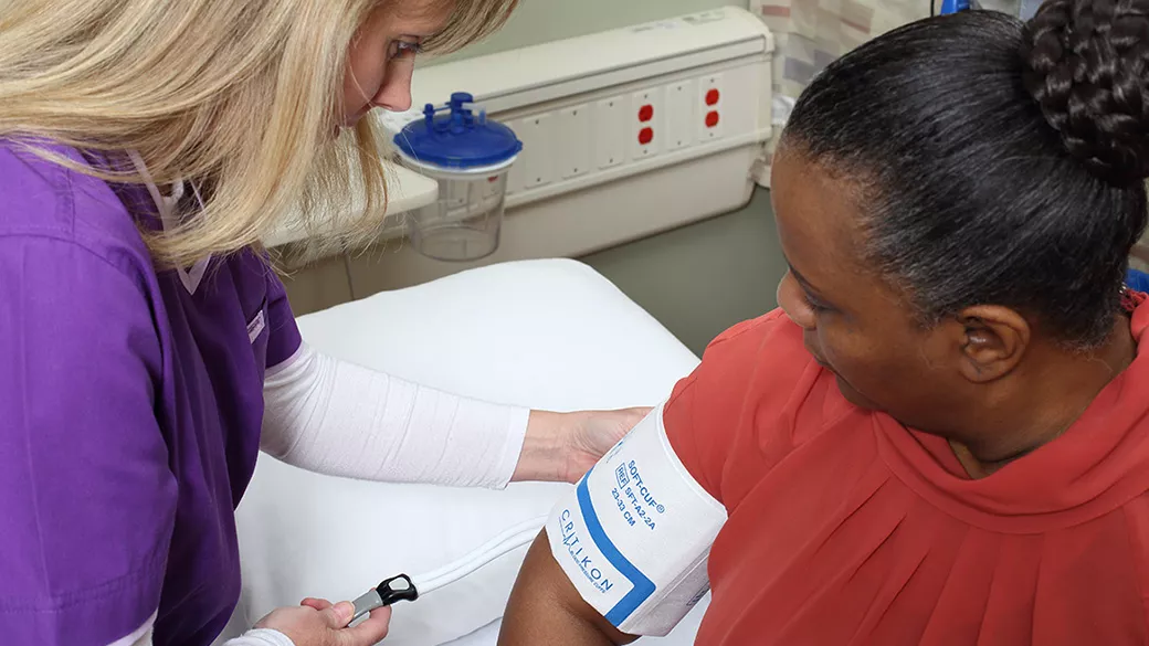 A patient wearing a blood pressure cuff