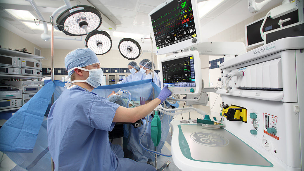 A clinician using Aisys CS2 Anesthesia Delivery System in an operating room