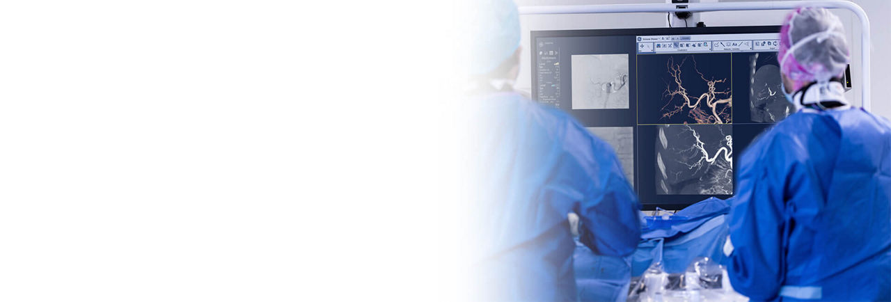 Two doctors reviewing CBCT scan results on a computer screen.