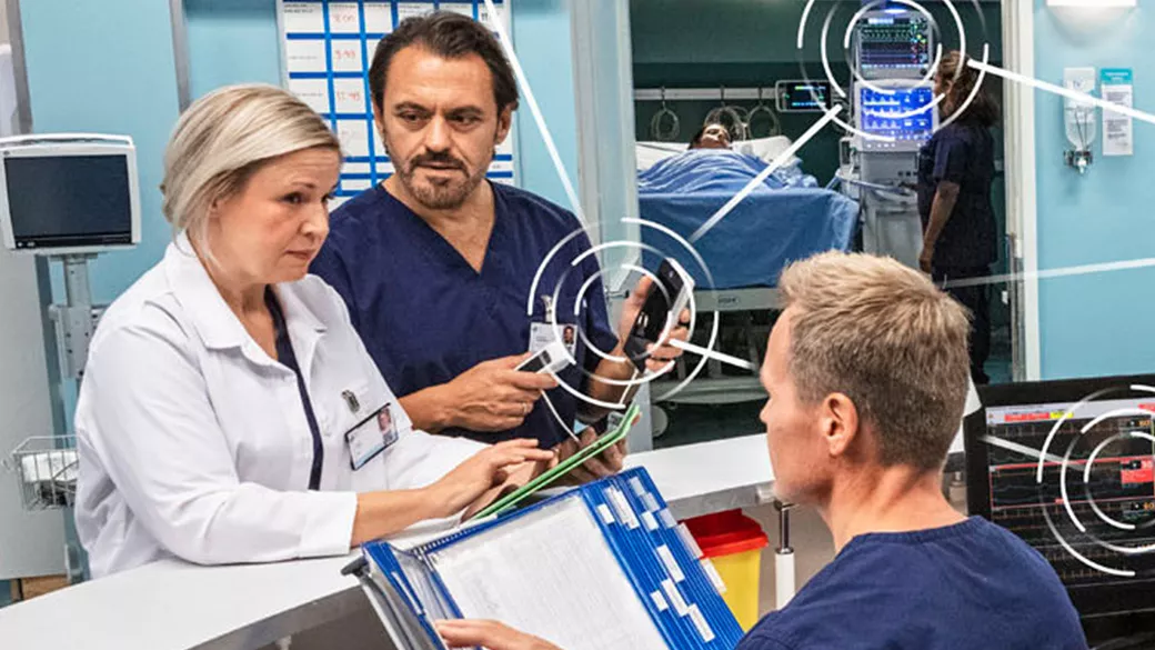 healthcare professionals discussing a patient using GE Healthcare's monitoring solutions