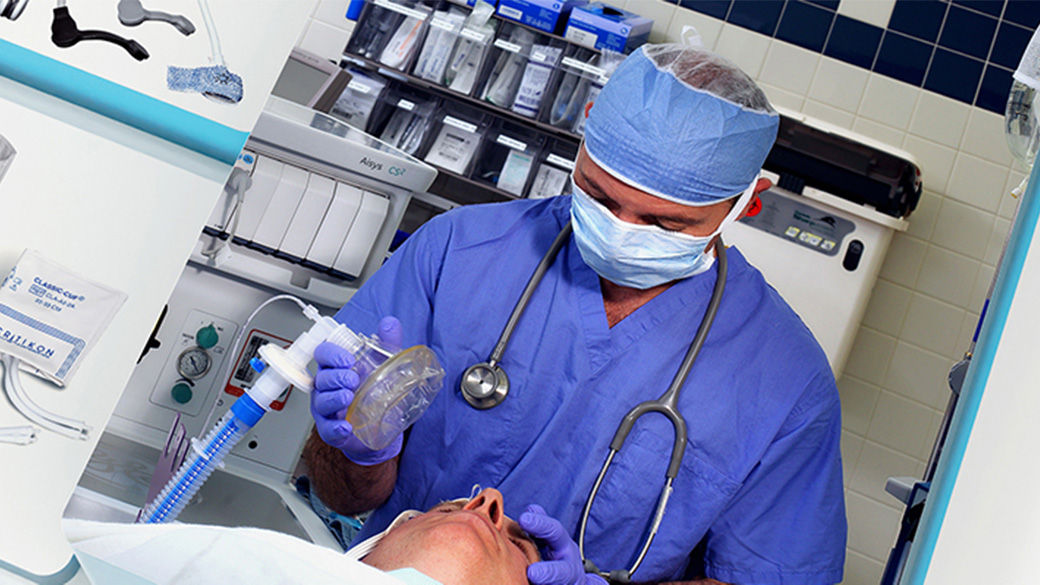 a doctor placing a ventilator on a patient