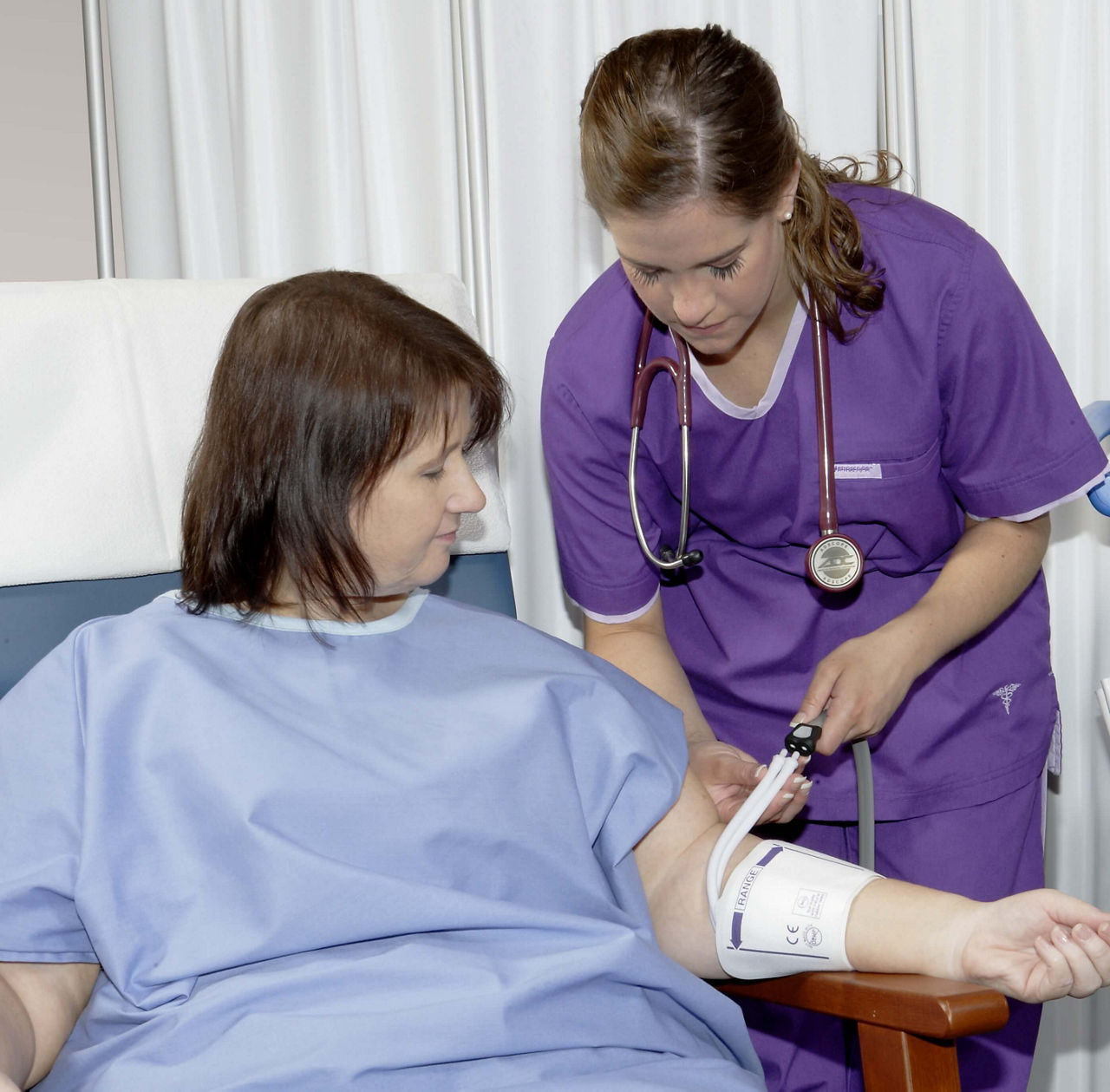 Clinician using a RADIAL-CUF blood pressure cuff on a patient's arm